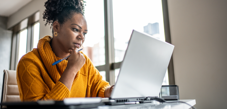 a woman working at a laptop.